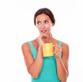 Worried brunette woman with coffee mug