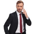 Worried businessman talking on the phone and looking to side Royalty Free Stock Photo