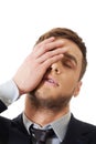 Worried businessman touching his forehead. Royalty Free Stock Photo
