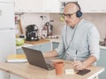 Worried businessman working from home on laptop - Serious adult man having video call with his boss - worries about the economic Royalty Free Stock Photo