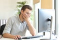 Worried businessman working online