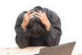 Worried businessman . a young man sits at his Desk and holds his hands on his head Royalty Free Stock Photo