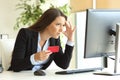 Worried businesswoman buying with credit card