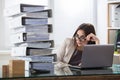 Worried Businesswoman Looking At Folders Stack Royalty Free Stock Photo