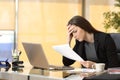 Worried businesswoman reading a notification