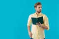 Worried casual man looking away while holding a book Royalty Free Stock Photo