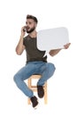 Worried casual man talking on phone, holding speech bubble Royalty Free Stock Photo