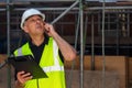 Worried Male Builder Architect Contractor on Building Site Using Phone Royalty Free Stock Photo