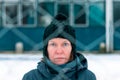 Worried concerned serious woman behind chain-link fence