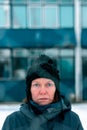 Worried concerned serious woman behind chain-link fence