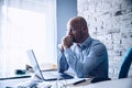 Worried confused man in shirt working on laptop computer Royalty Free Stock Photo