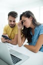 Worried couple calculating their bills with laptop in the kitchen Royalty Free Stock Photo