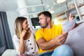 Couple checking bank account trouble sitting on a couch in the living room at home Royalty Free Stock Photo