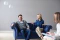 Worried couple listening to psychologist during a therapy sitting on a sofa at home Royalty Free Stock Photo