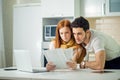 Worried couple paying their bills online with laptop at home in living room Royalty Free Stock Photo