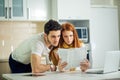 Worried couple paying their bills online with laptop at home in living room Royalty Free Stock Photo