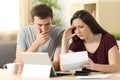 Worried couple reading together a letter Royalty Free Stock Photo