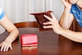 Worried couple sitting at the table with empty wallets Royalty Free Stock Photo