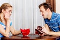 Worried couple sitting at the table with empty wallets Royalty Free Stock Photo