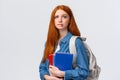 Worried cute and nervous redhead teenage girl scared parents scold her for skipping class, biting lip anxiously looking Royalty Free Stock Photo