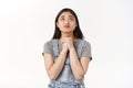 Worried cute silly hopeful intense asian girl dark short haircut pouting look up talking god clench hands together pray