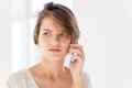 Worried disturbed young woman talking on mobile phone Royalty Free Stock Photo