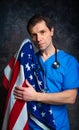 Worried doctor holding the American flag.