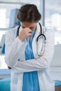 Worried doctor standing with hand on head Royalty Free Stock Photo