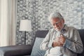 Worried elder senior man feeling bad, upset old middle aged grandfather touching chest feel sudden pain heartburn having heart Royalty Free Stock Photo