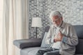 Worried elder senior man feeling bad, upset old middle aged grandfather touching chest feel sudden pain heartburn having heart Royalty Free Stock Photo