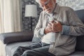 Worried elder senior man feeling bad, upset old middle aged grandfather touching chest feel sudden pain heartburn having heart Royalty Free Stock Photo