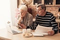 Worried Elderly Couple Using Laptop In Kitchen, Checking Domestic Finances Royalty Free Stock Photo