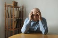 Worried elderly man with his head in his hands Royalty Free Stock Photo