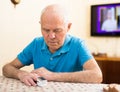 Worried elderly man measuring himself oxygen saturation at home Royalty Free Stock Photo