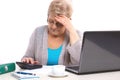 Worried elderly senior woman counting utility bills at her home, financial security in old age Royalty Free Stock Photo