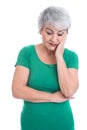 Worried elderly woman in green - isolated on white Royalty Free Stock Photo