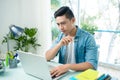 Worried entrepreneur young man working at desk on laptop looking Royalty Free Stock Photo