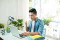 Worried entrepreneur young man working at desk on laptop looking Royalty Free Stock Photo