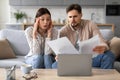 Worried european couple with documents and laptop at home Royalty Free Stock Photo