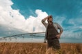 Worried farmer in barley field on a windy day Royalty Free Stock Photo