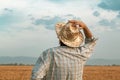 Worried farmer in barley field on a windy day Royalty Free Stock Photo