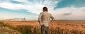 Worried farmer in barley field on a windy day Royalty Free Stock Photo