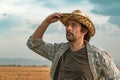 Worried farmer in barley field on a windy day Royalty Free Stock Photo