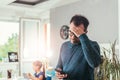 Worried father looking at smart phone