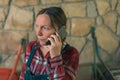 Worried female farmer talking on mobile phone