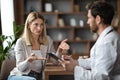 Worried Female Patient Talking To Doctor Man During Appointment In Office Royalty Free Stock Photo