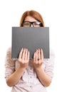 Worried female student hiding behind a book Royalty Free Stock Photo