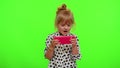 Worried funny addicted child girl enthusiastically playing drive racing video games on mobile phone