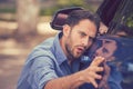 Worried funny looking man obsessing about cleanliness of his new car Royalty Free Stock Photo