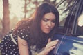 Worried funny looking woman obsessing about cleanliness of her car Royalty Free Stock Photo